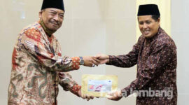 Gus Fat saat menyerahkan bantuan secara simbolis ke pengasuh panti Al-Hasan, Miftakhul Hinan.