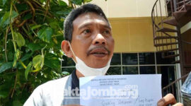 M Gading Setyawan (50) warga Desa Gadingmangu, Kecamatan Perak, Kabupaten Jombang, saat menunjukkan tanda terima pengaduannya ke Polda Jatim, Jumat (4/3/2022).